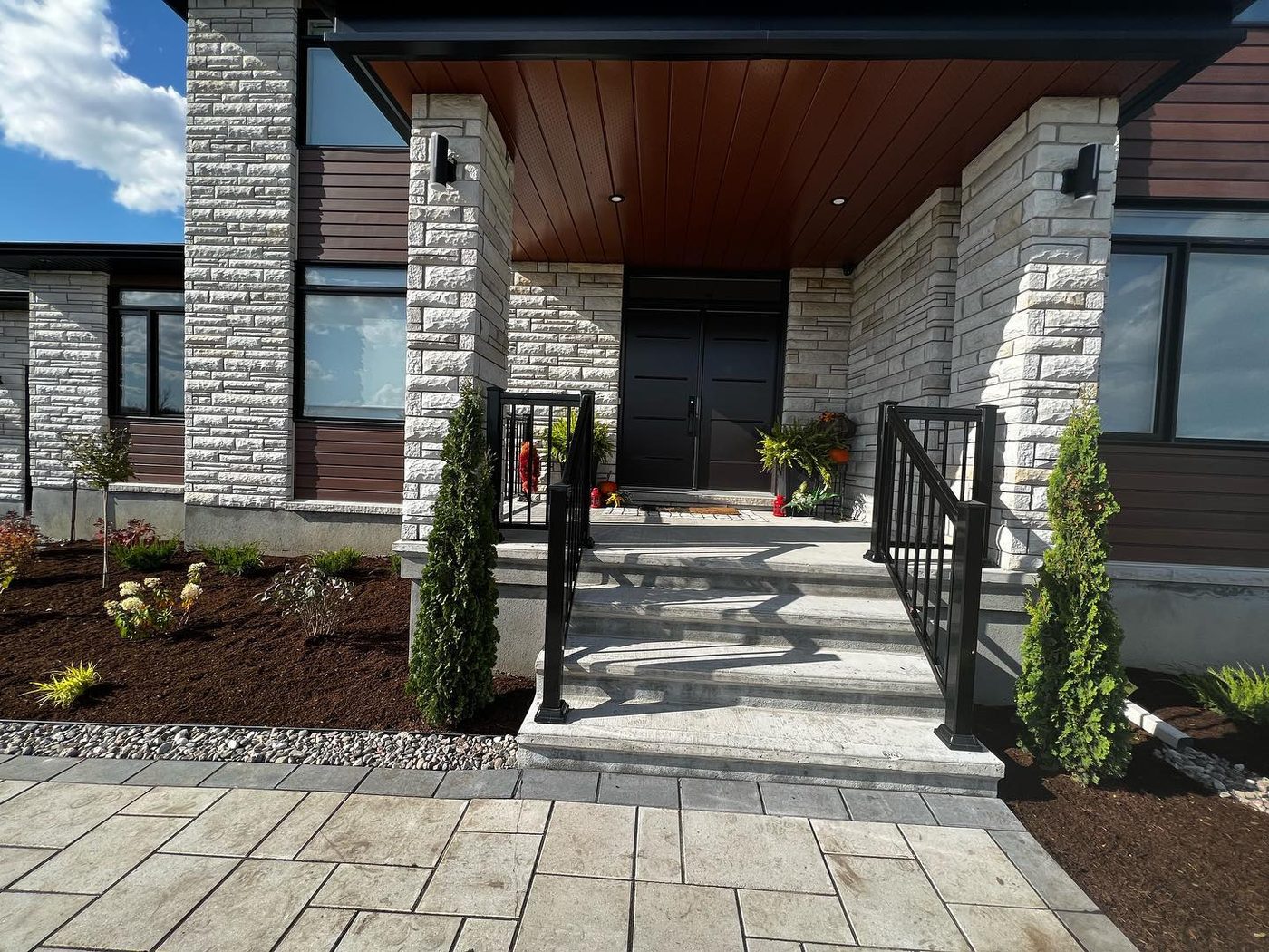 Modern stone home with newly installed garden